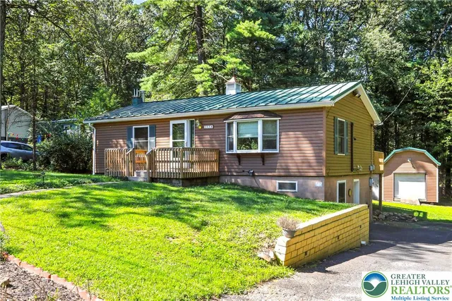 a front view of house with yard and outdoor seating