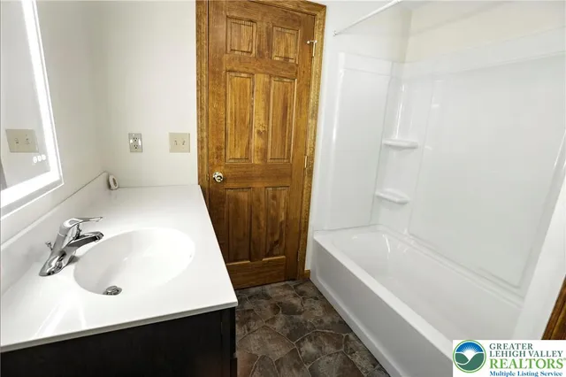 a bathroom with a sink a bathtub and a shower