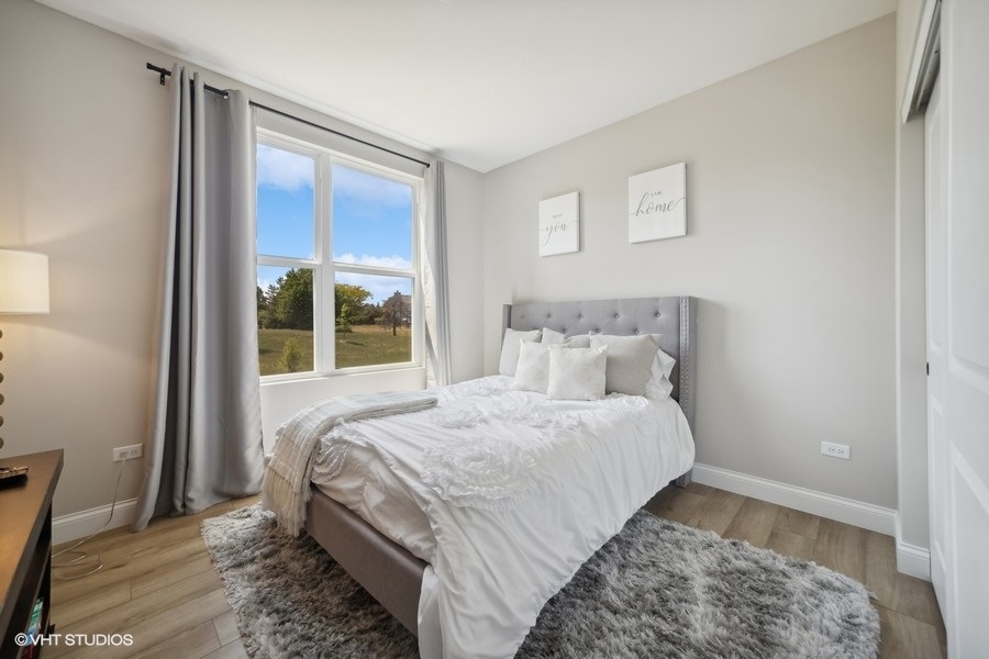 780 Treeline Drive Algonquin, IL 60102 - Photo 15 of 24 a bedroom with a bed lamp and a large window