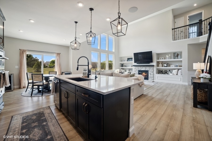 780 Treeline Drive Algonquin, IL 60102 - Photo 19 of 24 a kitchen with granite countertop a stove top oven a sink dishwasher a dining table and chairs with wooden floor