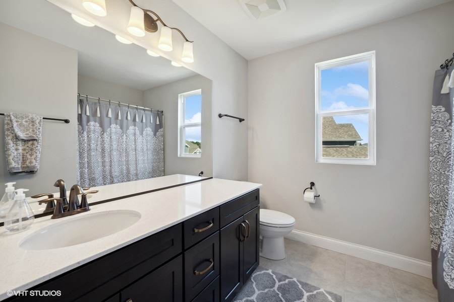 780 Treeline Drive Algonquin, IL 60102 - Photo 21 of 24 a bathroom with a double vanity sink mirror and toilet