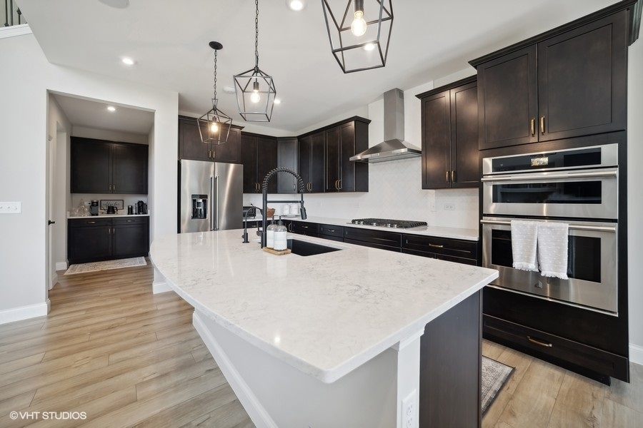 780 Treeline Drive Algonquin, IL 60102 - Photo 4 of 24 a large kitchen with stainless steel appliances a large counter top space a stove and a refrigerator
