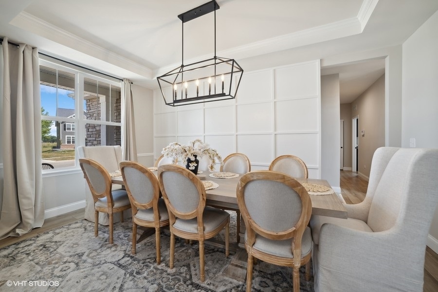 780 Treeline Drive Algonquin, IL 60102 - Photo 6 of 24 a dining room with furniture a chandelier and wooden floor