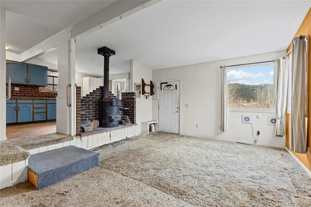 a view of a livingroom with an empty space and a fireplace