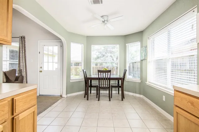 a dining room with furniture and window