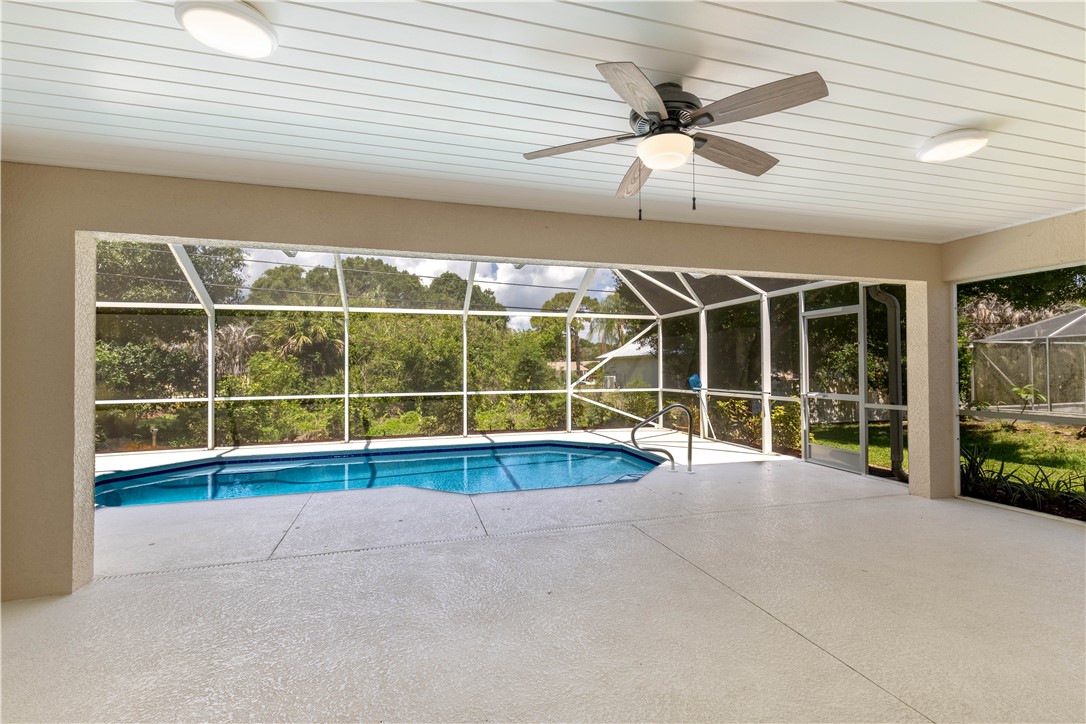 414 Ash Street Sebastian, FL 32958 - Photo 28 of 36 a view of an empty room with a ceiling fan and a large window