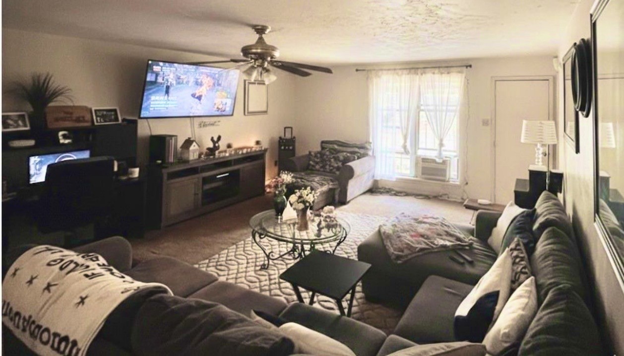 705 Phyllis Court Conroe, TX 77303 - Photo 11 of 17 a living room with furniture and a flat screen tv