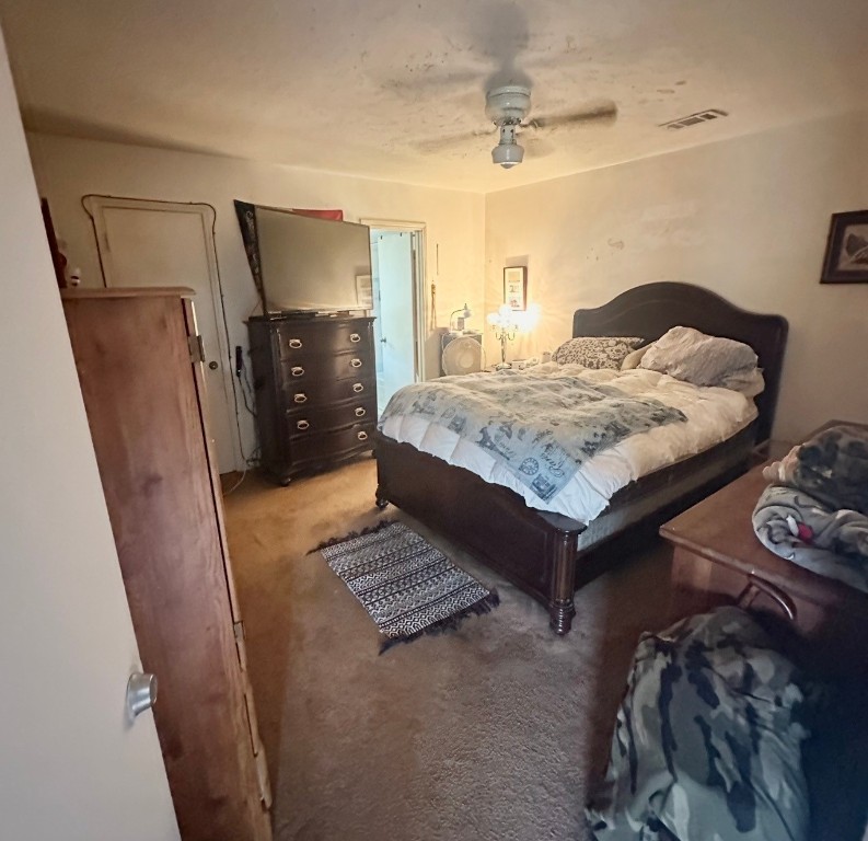 705 Phyllis Court Conroe, TX 77303 - Photo 12 of 17 a bedroom with a bed and a mirror on the dresser
