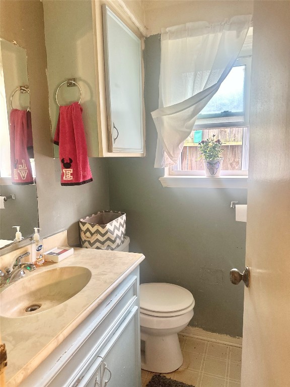 705 Phyllis Court Conroe, TX 77303 - Photo 17 of 17 a bathroom with a sink vanity mirror and toilet