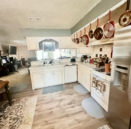 a dining room with furniture and a kitchen view