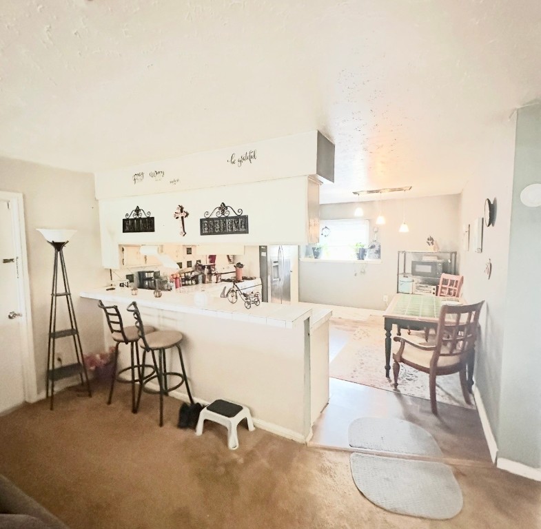 705 Phyllis Court Conroe, TX 77303 - Photo 10 of 17 a living room with furniture a flat screen tv and a table