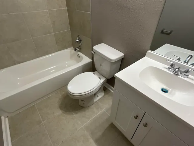 a bathroom with a sink toilet and bathtub