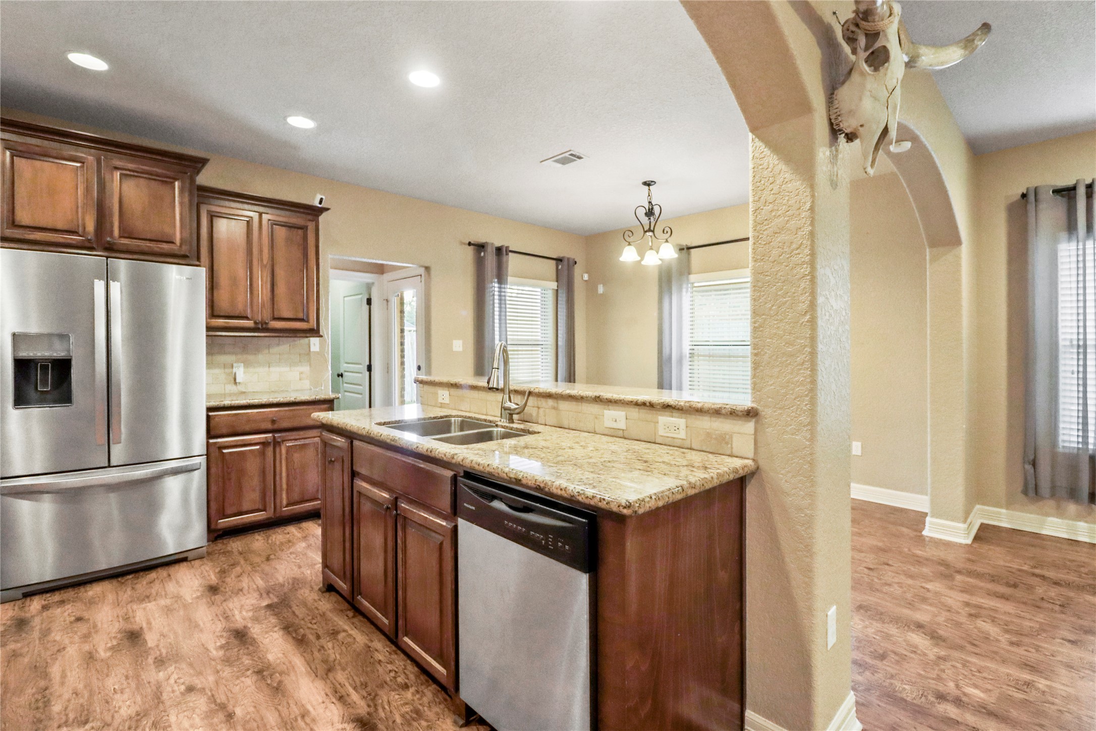1012 Rosewood Lane Angleton, TX 77515 - Photo 11 of 21 a kitchen with stainless steel appliances granite countertop a sink stove and refrigerator