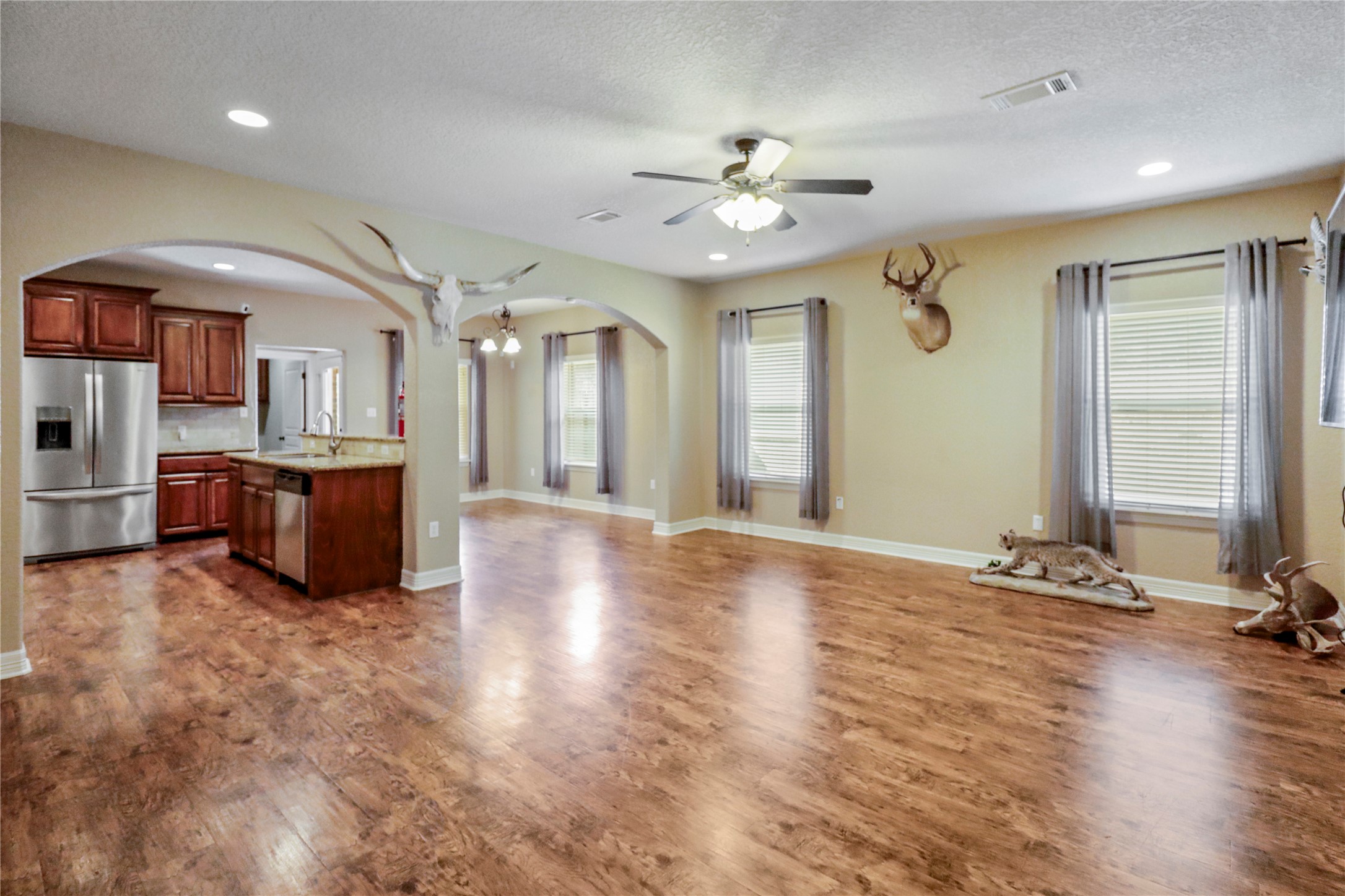 1012 Rosewood Lane Angleton, TX 77515 - Photo 5 of 21 a view of a livingroom with a furniture hardwood floor and a ceiling fan