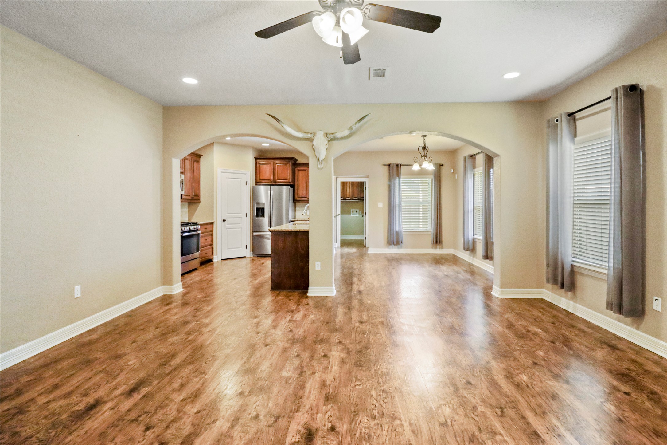 1012 Rosewood Lane Angleton, TX 77515 - Photo 7 of 21 a view of a big room with wooden floor and a kitchen