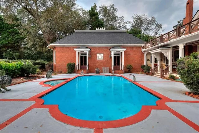 a living room with furniture a chandelier and a fireplace