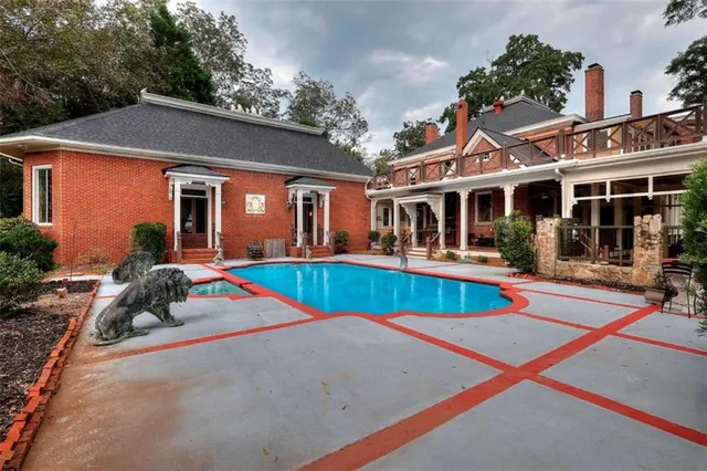 a view of a hallway with wooden floor and a chandelier