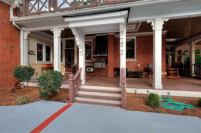 a living room with fireplace furniture and a large window