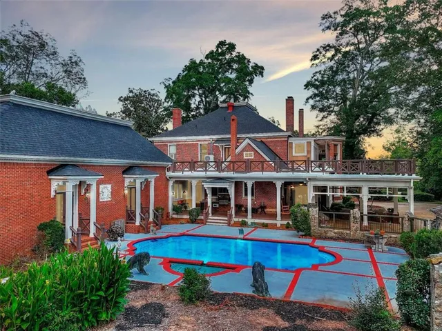 a front view of multiple houses with yard and swimming pool