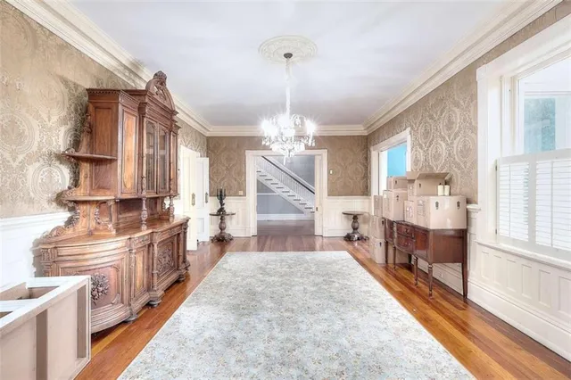 a living room with furniture a window and a chandelier