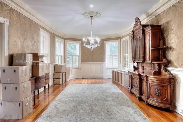 a living room with furniture a fireplace and a chandelier