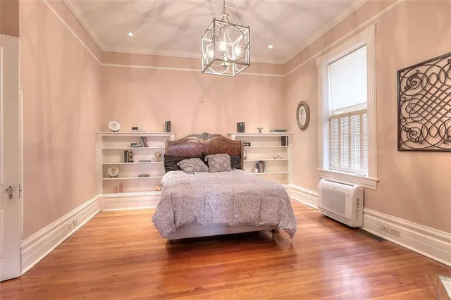 a view of a hallway with wooden floor and windows