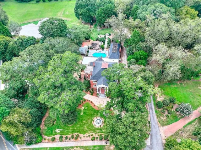 an aerial view of a house with a yard and outdoor seating