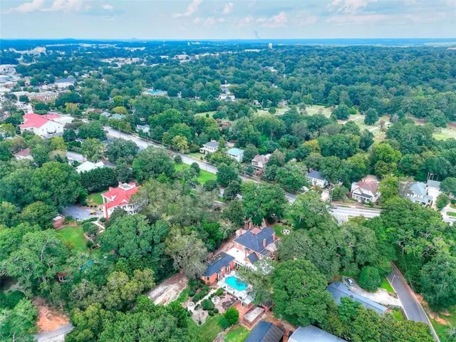 an aerial view of a house with a yard pool outdoor seating and yard