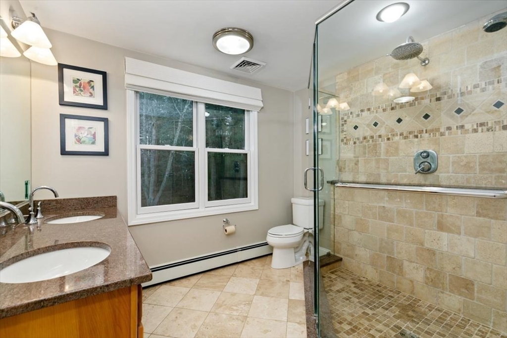 50 Stonecleave Road Boxford, MA 01921 - Photo 27 of 42 a bathroom with a granite countertop sink toilet a mirror and shower