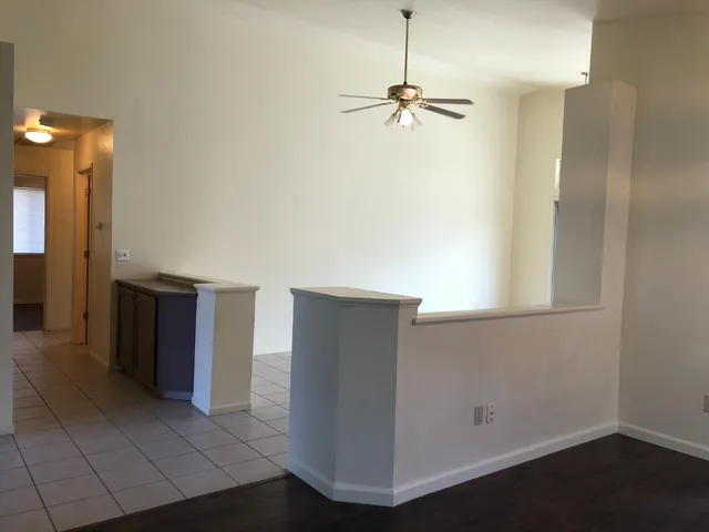 an empty room with closet and windows