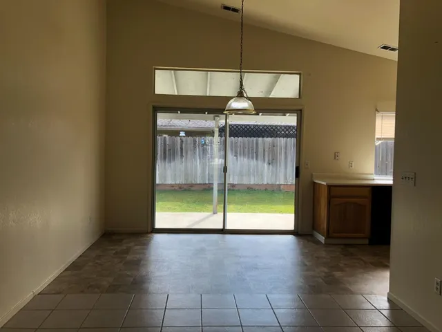 a view of a livingroom with a furniture and floor to ceiling window