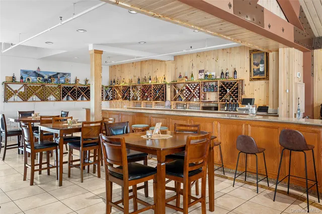 a dining table with chairs and view of kitchen