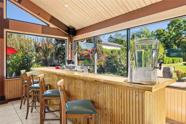 a view of an outdoor dining space with a table and chairs
