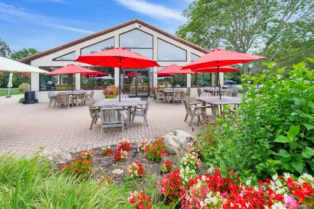 an outdoor space with patio furniture and white umbrellas