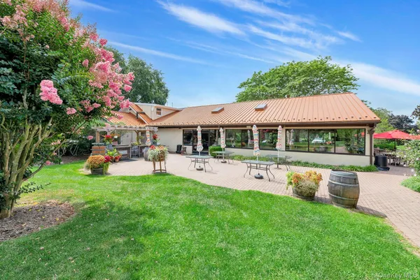 a front view of a house with a garden and swimming pool