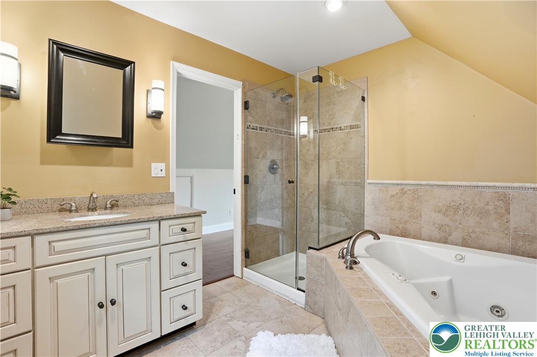 2014 Linden Street Bethlehem, PA 18017 - Photo 38 of 85 Indulge in a primary bathroom designed for relaxation with a spacious soaking tub and a sleek, glass-enclosed shower.