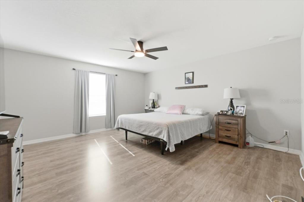 2175 Old Mining Road Lakeland, FL 33801 - Photo 17 of 51 a spacious bedroom with a bed and a chandelier