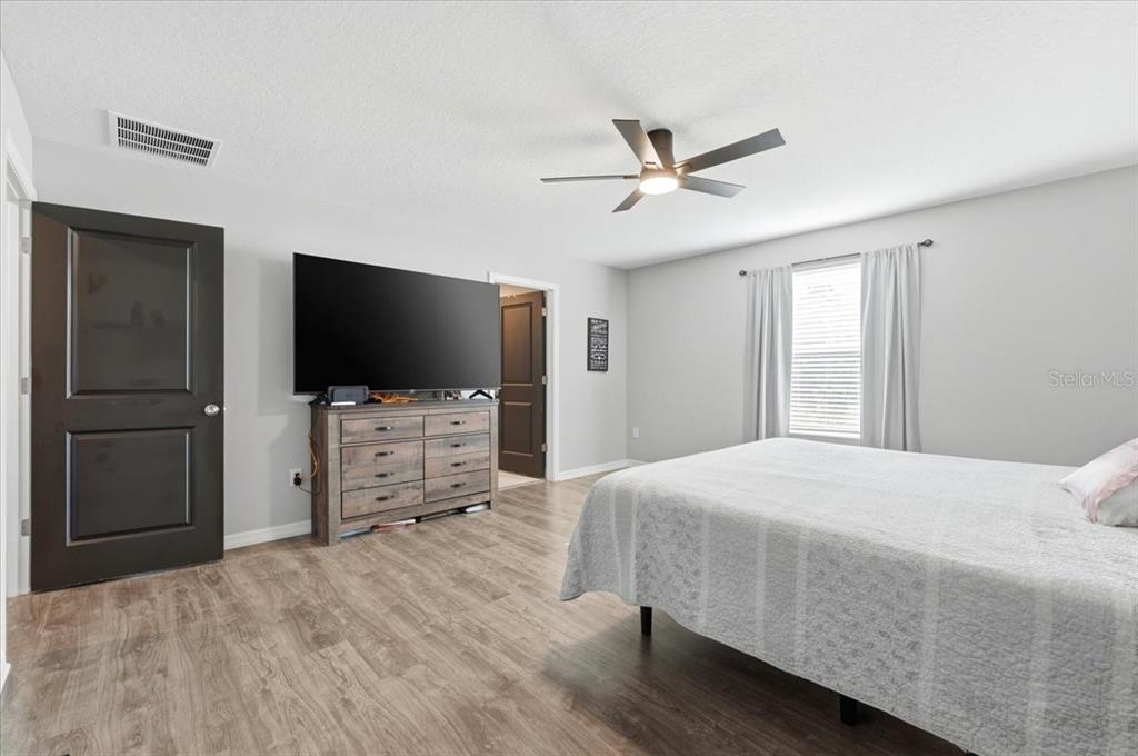 2175 Old Mining Road Lakeland, FL 33801 - Photo 18 of 51 a bedroom with a bed and a flat screen tv