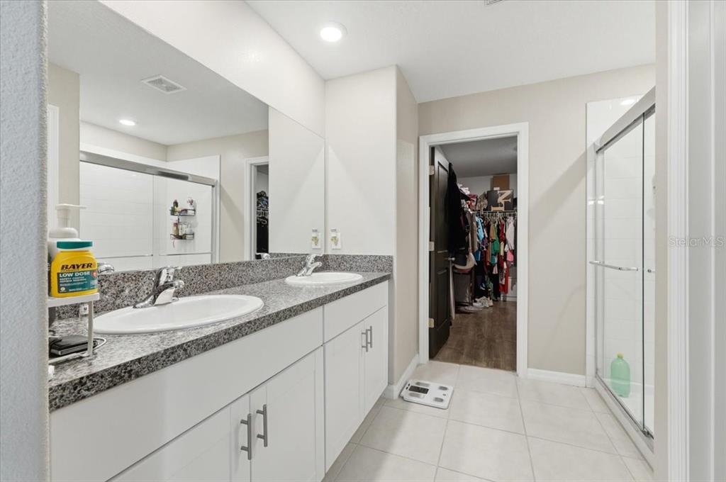 2175 Old Mining Road Lakeland, FL 33801 - Photo 20 of 51 a en suite bathroom with a granite countertop sink and a mirror