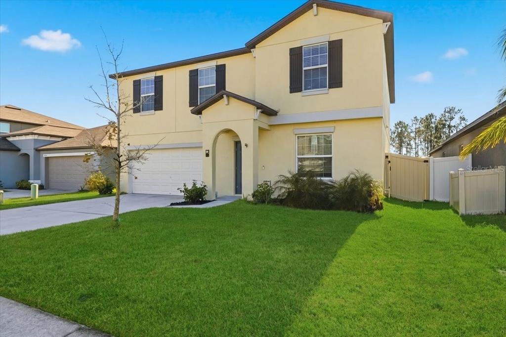 2175 Old Mining Road Lakeland, FL 33801 - Photo 2 of 51 a front view of a house with a yard and garage