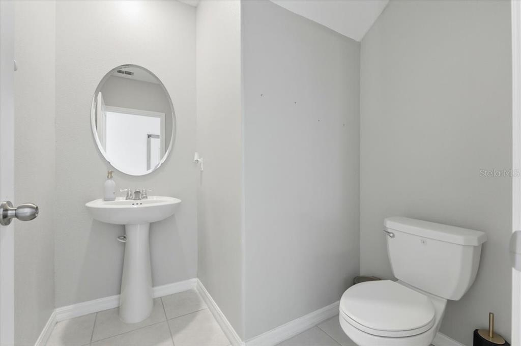 2175 Old Mining Road Lakeland, FL 33801 - Photo 36 of 51 a bathroom with a toilet a sink and a mirror