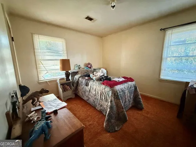 a bed room with a bed and a window