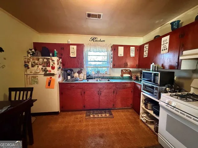 a kitchen with stainless steel appliances a stove and a refrigerator