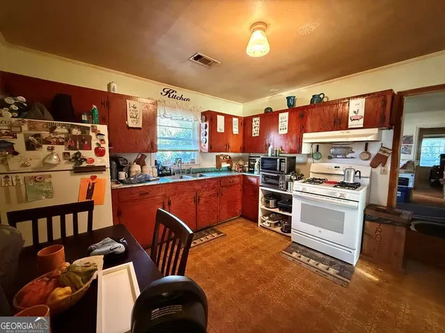 a kitchen with stainless steel appliances granite countertop a stove and a sink