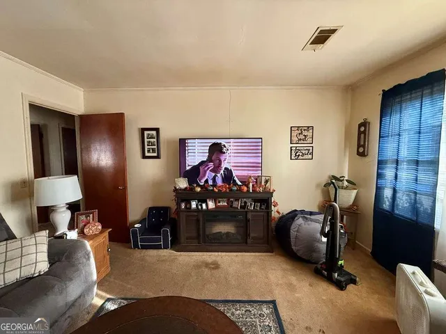 a living room with furniture and a lamp