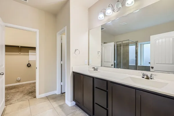 a bathroom with a sink double vanity and a mirror