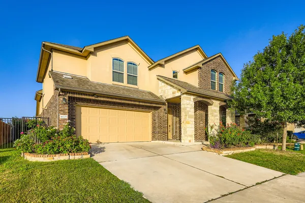a front view of a house with a yard and garage