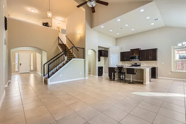 a view of a kitchen with furniture and a ceiling fan