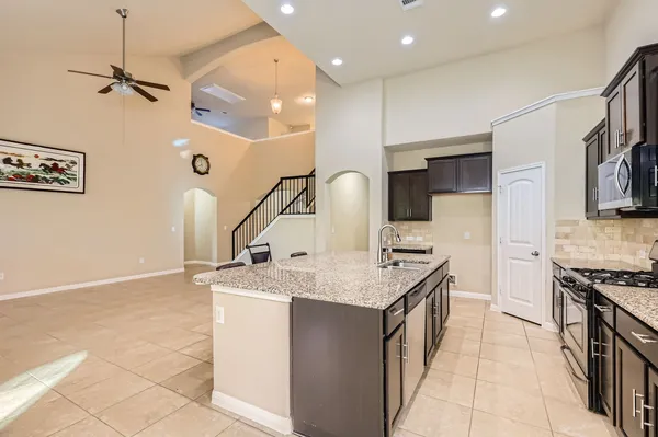 a kitchen with stainless steel appliances granite countertop a sink and a stove