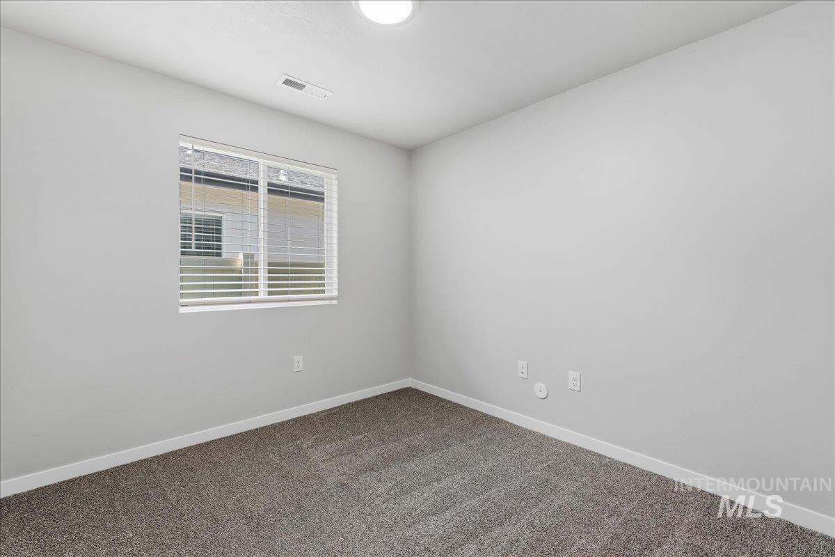 3091 S Green Boise, ID 83709 - Photo 16 of 27 Neutral-toned walls and plush carpet flooring create a versatile interior space
